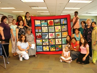 Women holding a quilt